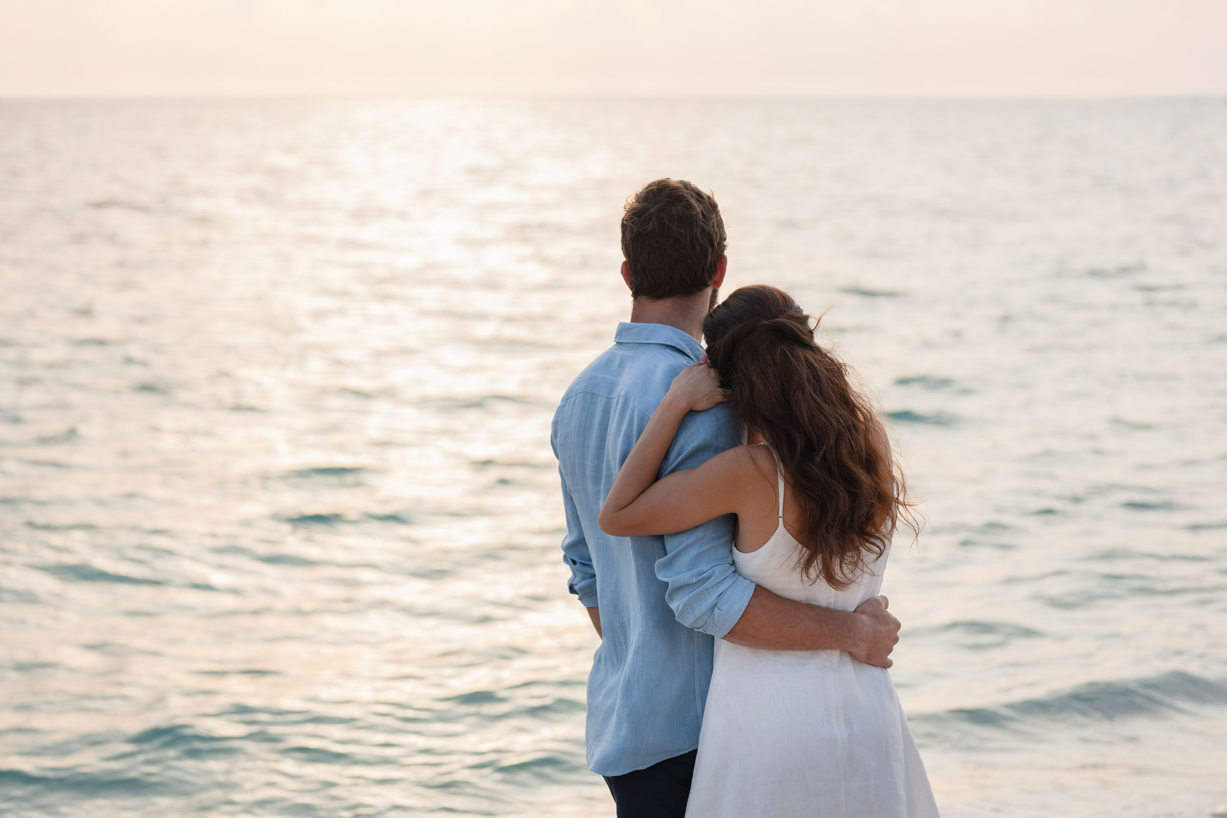 Man and woman enjoying wellness on their beachfront honeymoon in Cancun